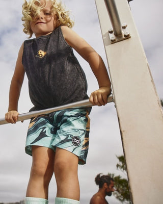 Kids Twister Boardshorts by Alphabet Soup for boys aged 2-7. Featuring melon/mint/black swirl paint print colorway, recycled polyester microfiber. These shorts feature an adjustable drawcord and a faux fly, plus a secure back pocket complete with a woven logo patch.