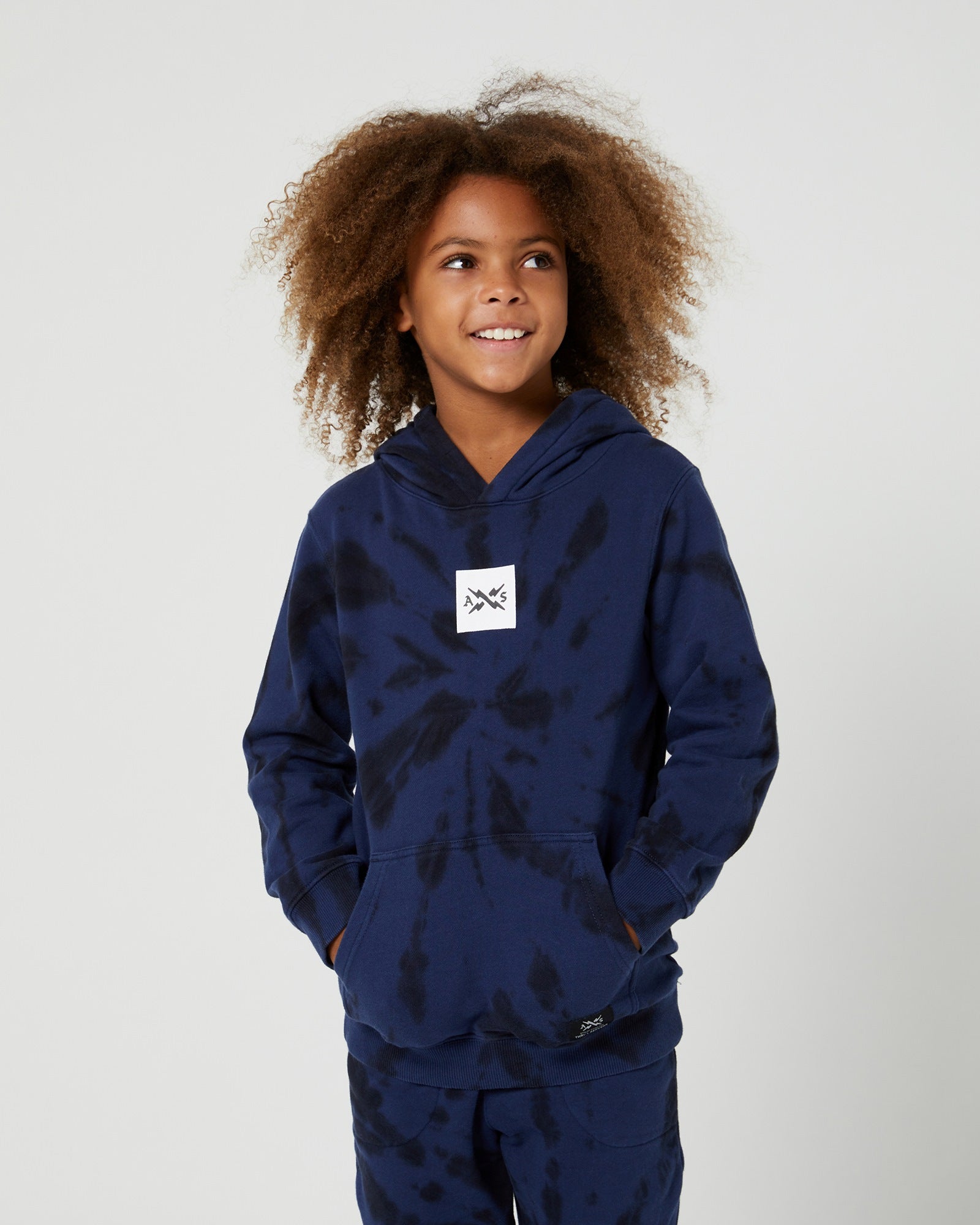 Alphabet Soup Teen Box Hoodie in midnight blue tie dye, made with 100% cotton and a tie-dye fabric, your little skater will love the oversized fit, kangaroo pocket, and logo embroidery patch on the centre chest.