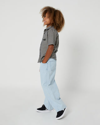Boys Alphabet Soup's Kids Check It Short Sleeve Shirt is made from 100% cotton and features a curved hemline, button through placket, and open chest pocket. Ideal for any drop-in, with yarn check fabric and embroidered art.