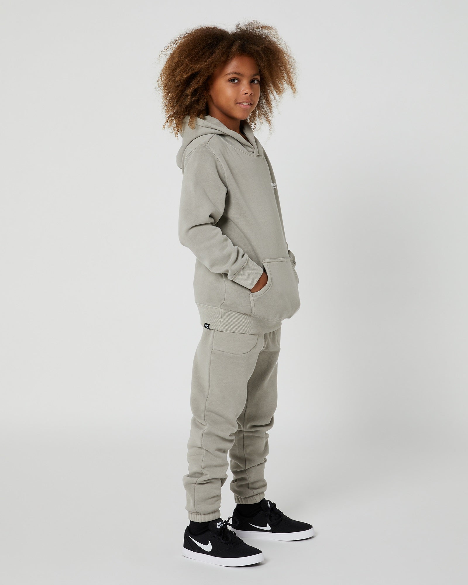 Teen Boys San Clemente Trackpant in Concrete by Alphabet Soup featuring a vintage garment dye wash, heavy brushed back fleece, and puff print design on the front leg create the perfect blend of comfort and style. Elasticated waist and ribbed cuff ankles ensure an all-day fit.