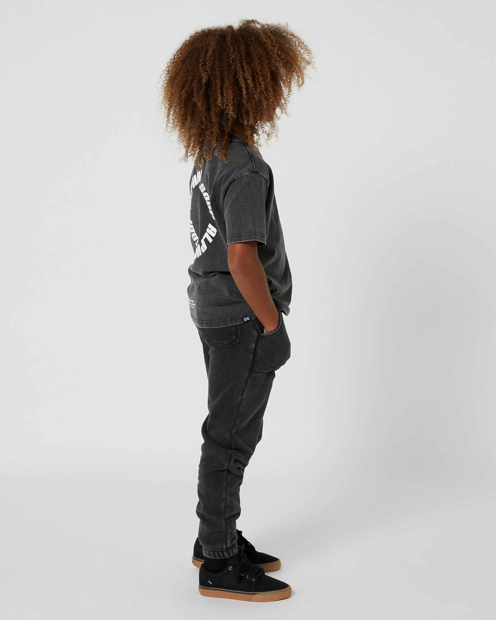Kids San Clemente Trackpant in Steel Grey by Alphabet Soup featuring a vintage garment dye wash, heavy brushed back fleece, and puff print design on the front leg create the perfect blend of comfort and style. Elasticated waist and ribbed cuff ankles ensure an all-day fit.