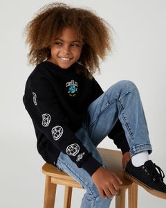 The Teens Boys Black Stay Chilled Crew by Alphabet Soup is a comfortable jumper with a crew neck, long sleeves, and bold embroidered art designs on the front and arms. It also features ribbed cuffs and a hemline for a snug fit, and a woven brand patch for a skater-inspired look.