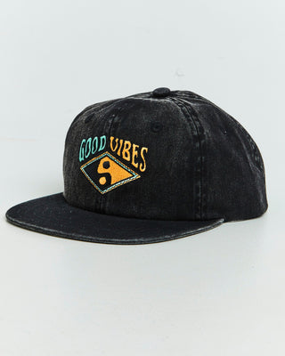 Good Vibes Cap by Alphabet Soup for boys aged 2-16. Crafted in durable cotton canvas with adjustable snap fastening, acid black wash, multicoloured embroidery, and classic 6-panel trucker design with “Good Vibes” multi coloured embroided artwork to front.