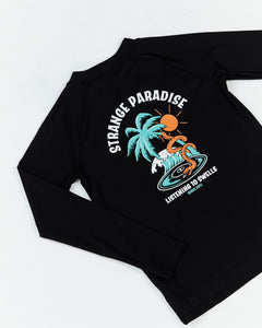 Kids black Ripple Long Sleeve Rashie by Alphabet Soup is made for boys aged 2-7. Constructed with recycled plastic and spandex, this piece has stretch for a snug fit and UPF 50 sun protection. Plus, the chest and back are printed with the exclusive retro surf 'Strange Paradise' design in white, green and orange.