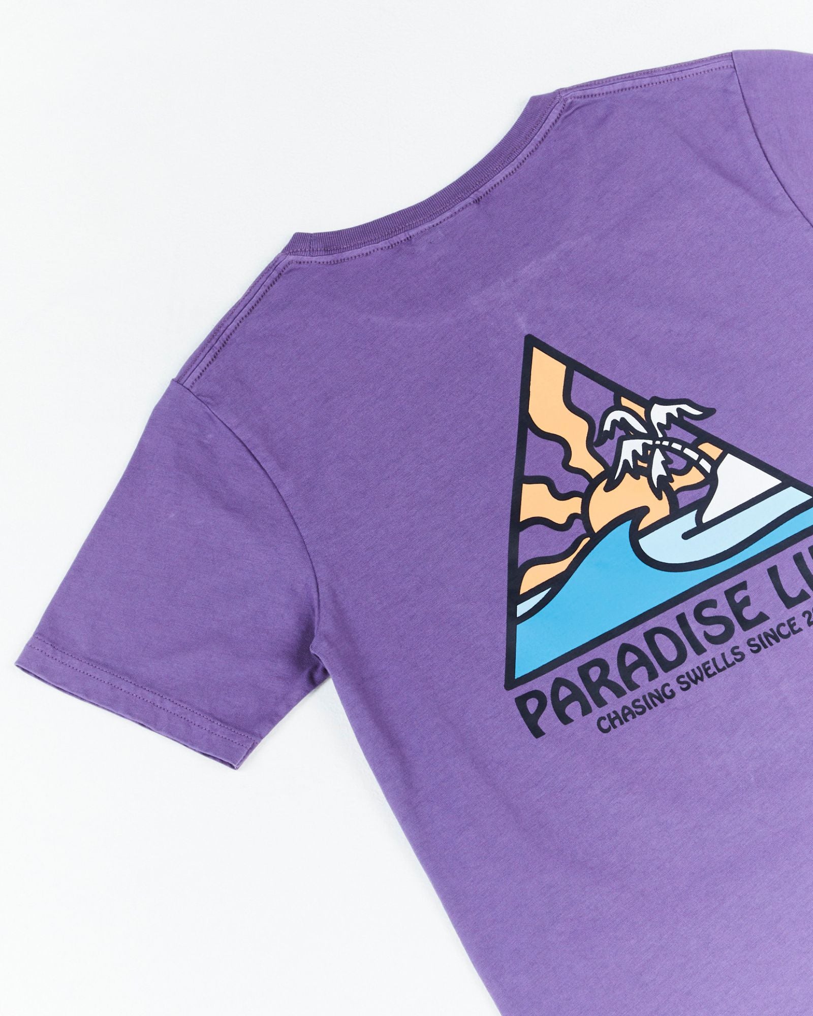 Alphabet Soup's Kids Thruster Tee for boys aged 2-7. Crafted from 100% Cotton Jersey. A purple pigment dye tee, regular fit, straight hemline, short sleeves, ribbed crew neckline, and a retro surf “Paradise Life” print to chest and back.