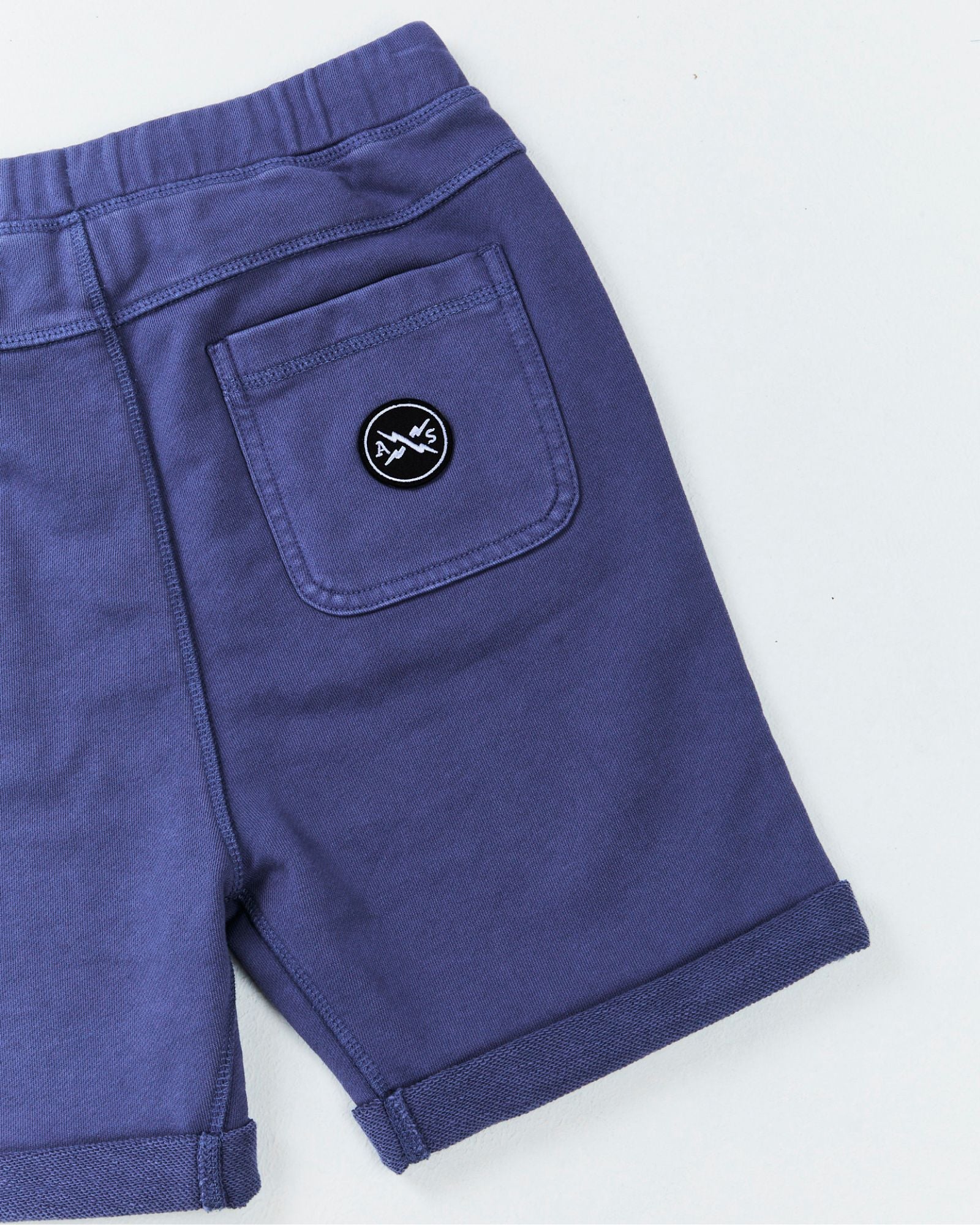 Alphabet Soup's Teen Comfy Shorts for boys aged 8-16. Featuring pigment dye print, heavy weight cotton, adjustable drawcord waist, rolled hem, faux fly, twin hand pockets, embroidered front pocket, back pocket logo patch.