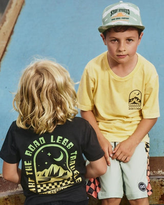 Alphabet Soup's Kids Mystical Tee in washed yellow cotton jersey for boys ages 2-7. Featuring a rad print “Take The Road Less Travelled” design on front and back, short sleeves, crew neck, and straight hemline.