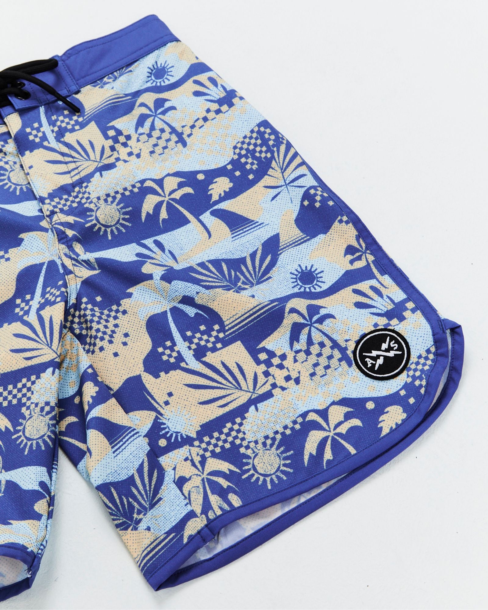 Alphabet Soup's Kids Poolside Boardshorts for boys aged 2-7. All-over tropical print in blues, drawstring waist, 4-way stretch, quick-dry Poly/Elastane blend and Velcro pocket.
