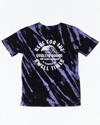 Teen Riptide Short Sleeve Tee by Alphabet Soup for boys aged 8-16. Crafted from 100% cotton jersey, this regular fit tee features short sleeves, a ribbed crew neckline, a straight hemline, and a two-tone diagonal purple and black tie dye. Plus, it has printed retro surf graphics to chest and back featuring “Here For The Swell Times”.