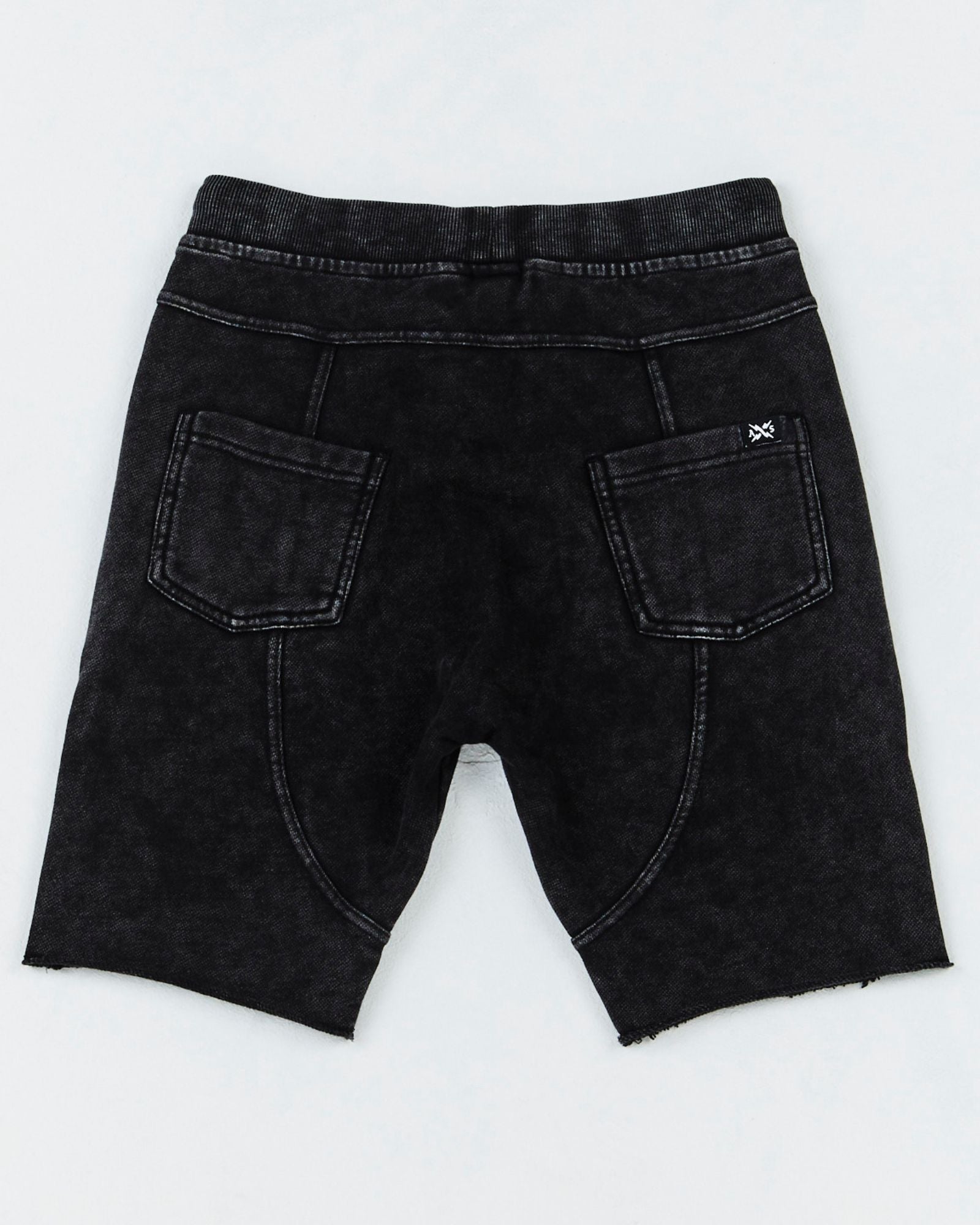  Teen Stacked Short from Alphabet Soup for boys aged 8-16. Featuring heavy-weight cotton, elastic waist, adjustable drawcord, acid black wash, faux- fly, raw hem, pockets with back panel detail, embroidery front pocket and woven label back pocket.