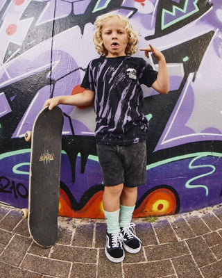  Teen Stacked Short from Alphabet Soup for boys aged 8-16. Featuring heavy-weight cotton, elastic waist, adjustable drawcord, acid black wash, faux- fly, raw hem, pockets with back panel detail, embroidery front pocket and woven label back pocket.