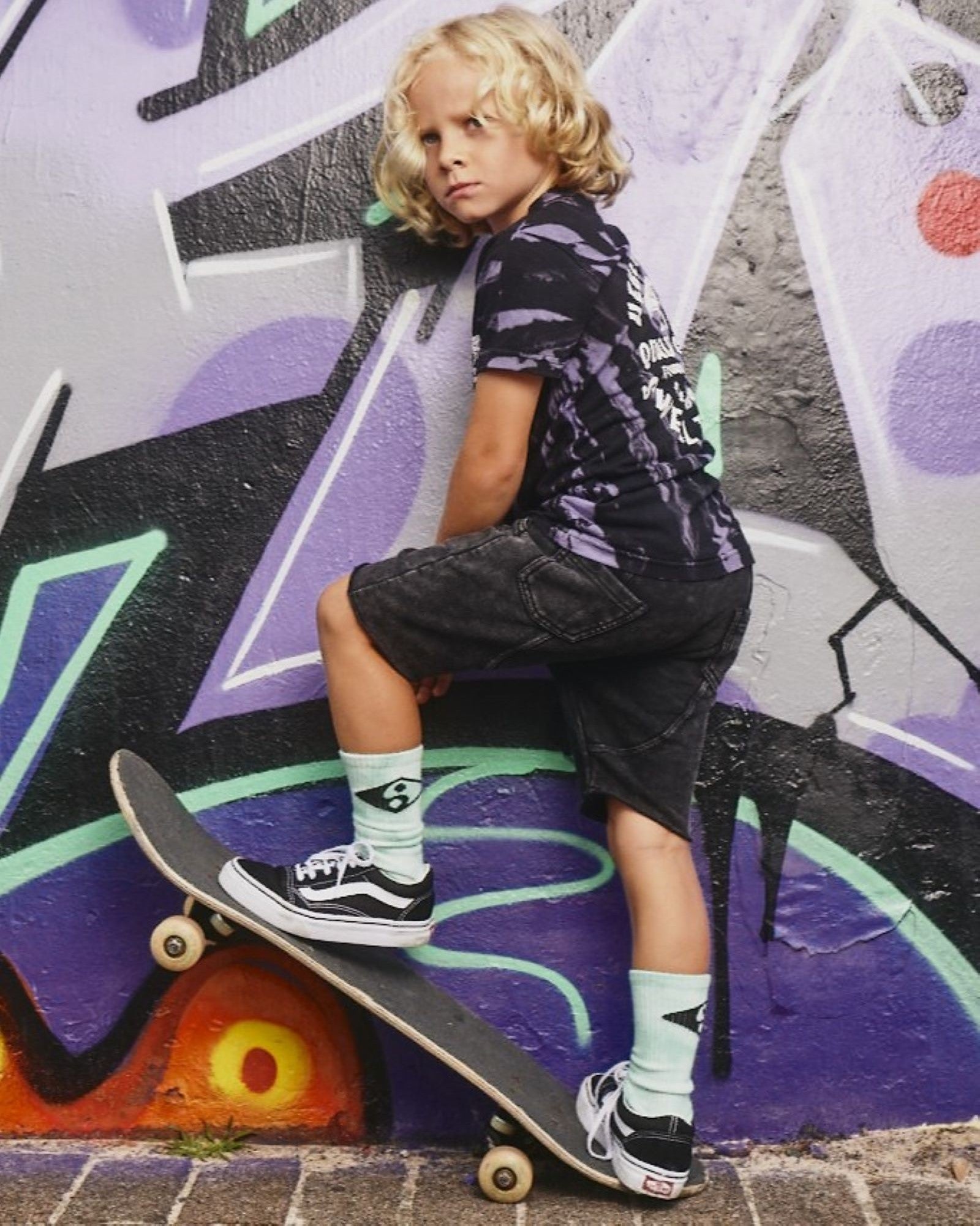 Kids Stacked Short from Alphabet Soup for boys aged 2-7. Featuring heavy-weight cotton, elastic waist, adjustable drawcord, acid black wash, faux- fly, raw hem, pockets with back panel detail, embroidery front pocket and woven label back pocket.