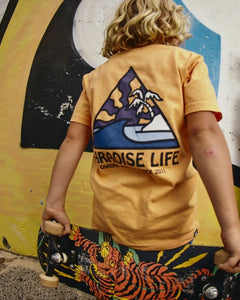 Alphabet Soup's Teen Thruster Tee for boys aged 8-16. Crafted from 100% Cotton Jersey. A melon pigment dye tee, regular fit, straight hemline, short sleeves, ribbed crew neckline, and a retro surf “Paradise Life” print to chest and back.
